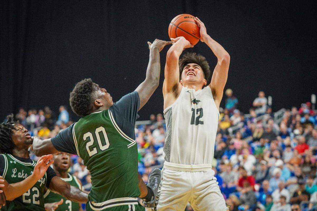 Plano East guard Jon Tran tries to get a shot off against Mansfield Lake Ridge’s Da’Sean Johnson in a Class 6A state semifinal on Friday, March 8, 2024 at the Alamodome in San Antonio, Texas. Plano East downed Lake Ridge 61-45.