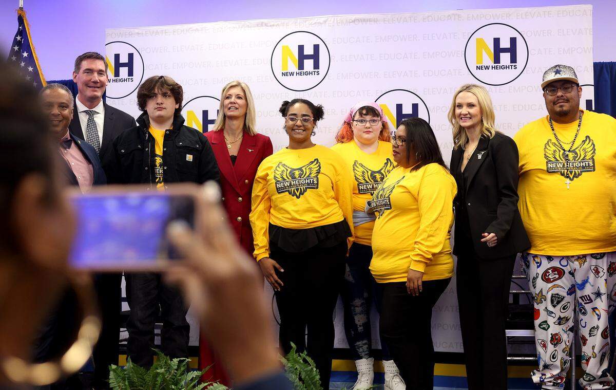 New Heights Adult High School's McCart Campus students take photos with school and public officials during the grand opening of the school on Thursday, October 30, 2025. The McCart Campus is the second New Heights school, which provides a free adult high school program for students in Fort Worth.