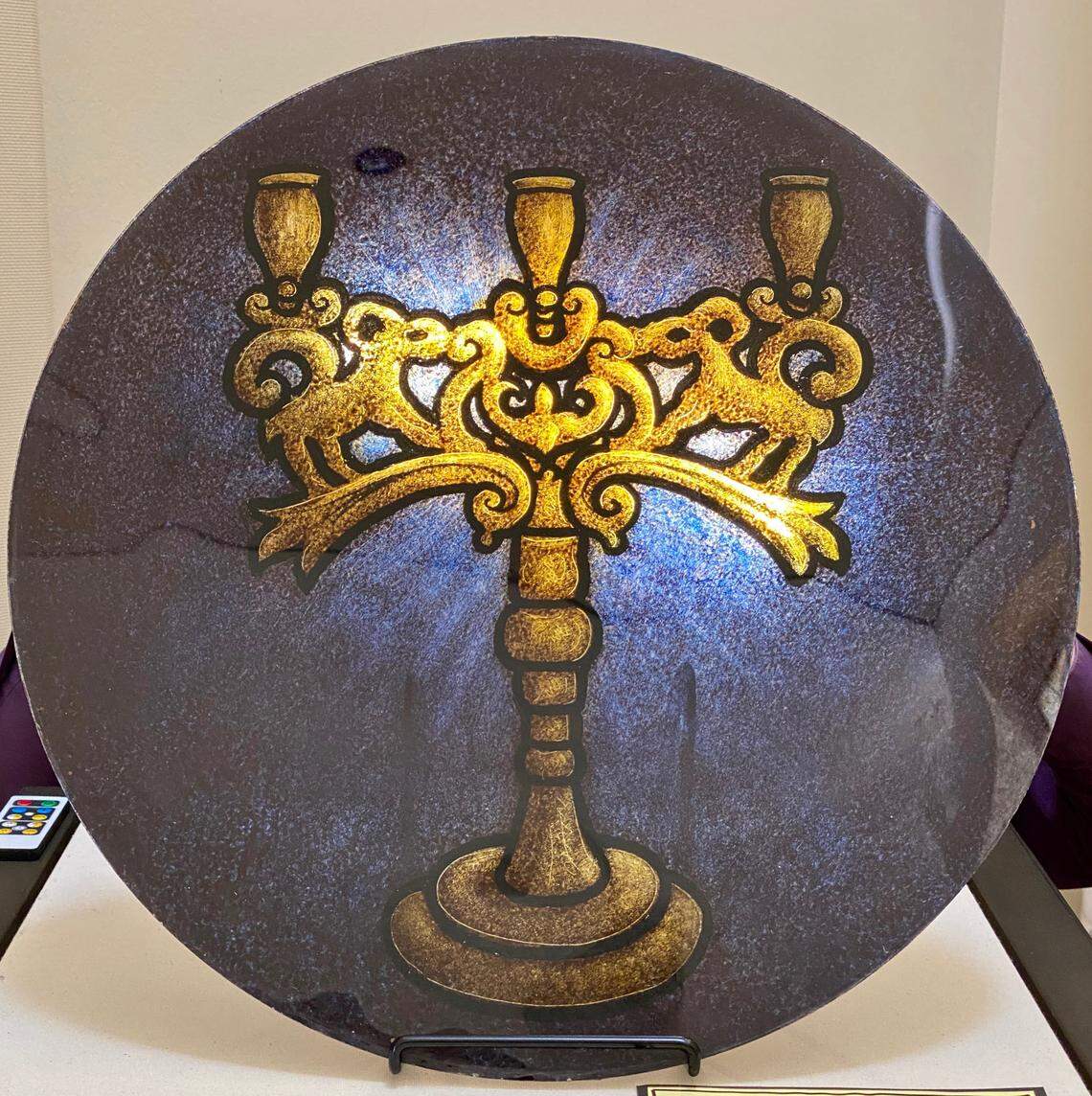 The triple-branched Sabbath candelabra, part of the stained-glass exhibit at Beth-El, was associated with artisans in Krakow, Poland, who created Jewish ceremonial objects before the Nazi occupation in World War II. 