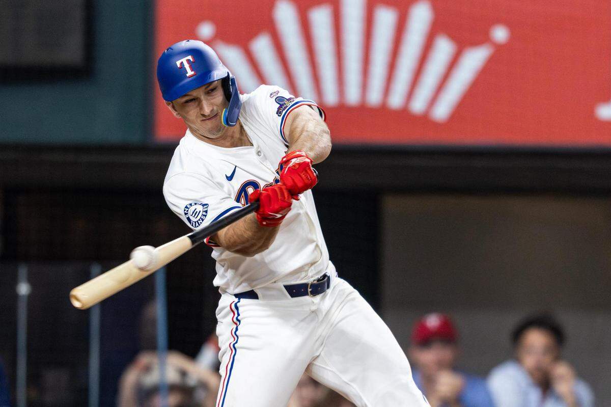 Texas Rangers designated hitter Wyatt Langford (36) swings at a pitch at the bottom of the tenth inning of their season opener against the Chicago Cubs at Globe Life Field in Arlington on Thursday, March 28, 2024.