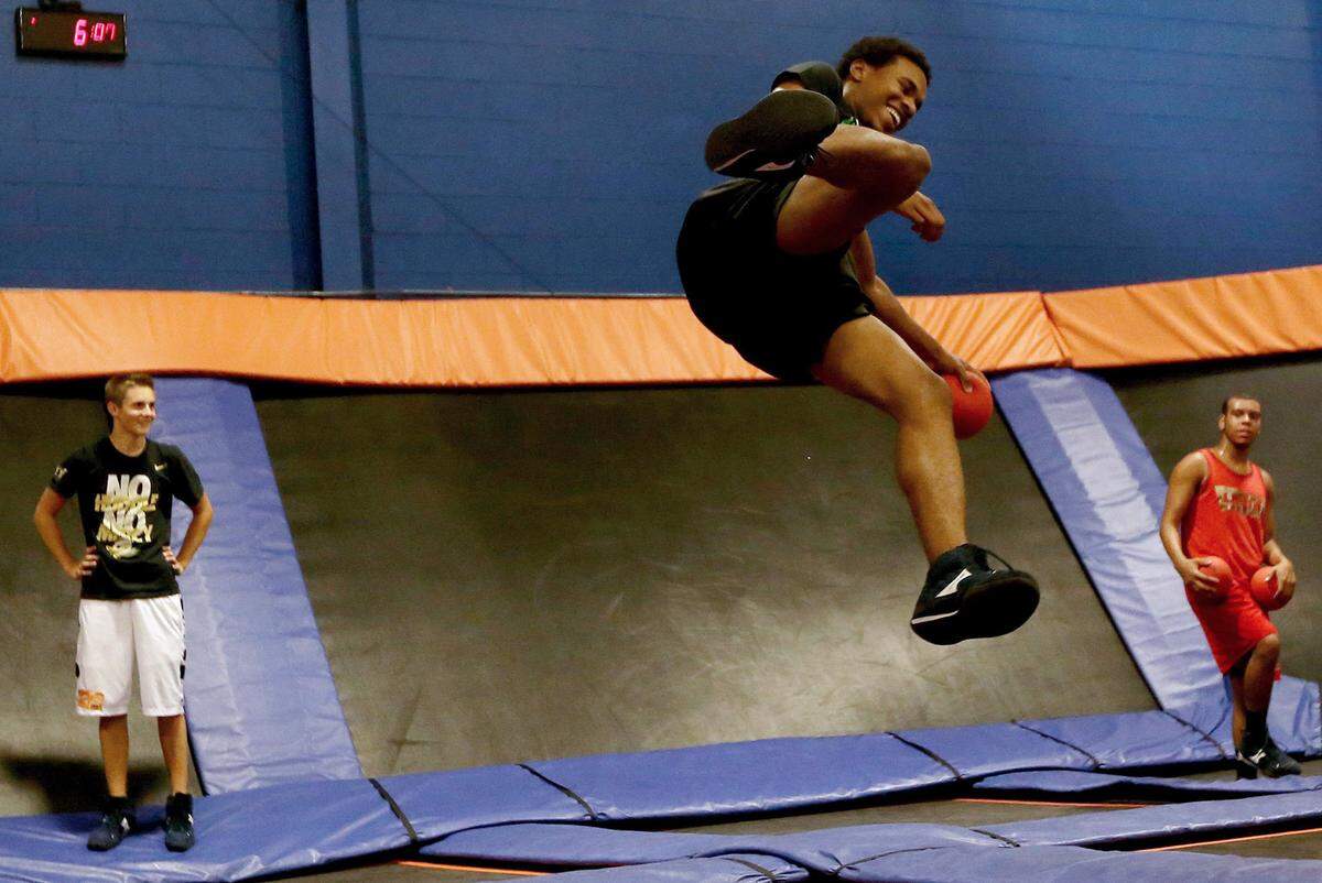 Akil Wade jumps on a trampoline at a center in Michigan in 2013. That state requires the businesses to tell jumpers about rules before they can participate, and they must accept the dangers of participating at the park. Texas has no such rules.