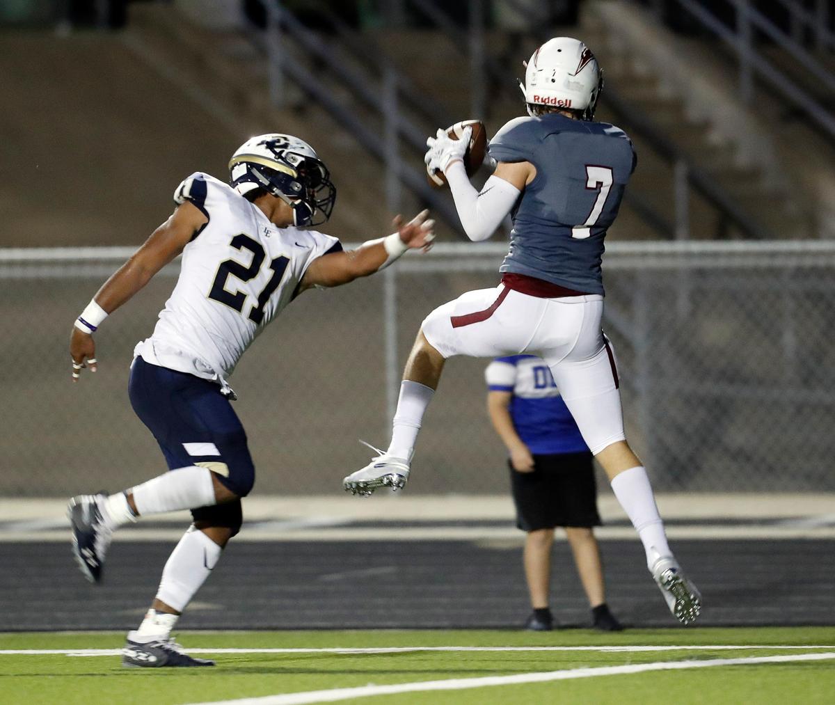 Keller Central wide receiver Landon Walker (7) grabs a pass in front of Little Elm linebacker Marquies Foster (21) and backs into the end zone during the first half of a high school football game at KISD Stadium in Keller, Texas, Saturday, Sept. 14, 2019. Central led 20-6 at the half. (Special to the Star-Telegram Bob Booth)