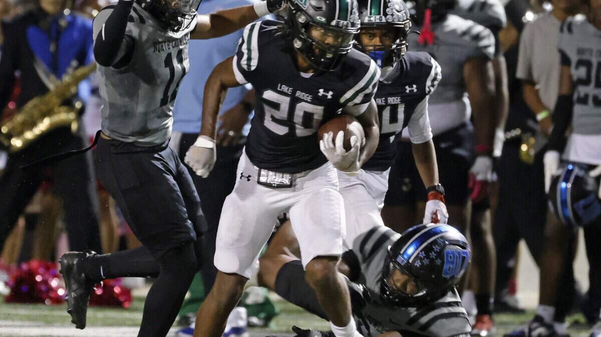 Lake Ridge running back Jaiden Cotton (20) gains yards along the sidelines during the first half of a UIL football game between North Crowley and Lake Ridge at Vernon Newsom Stadium in Mansfield, Texas, Thursday, October, 09, 2025.