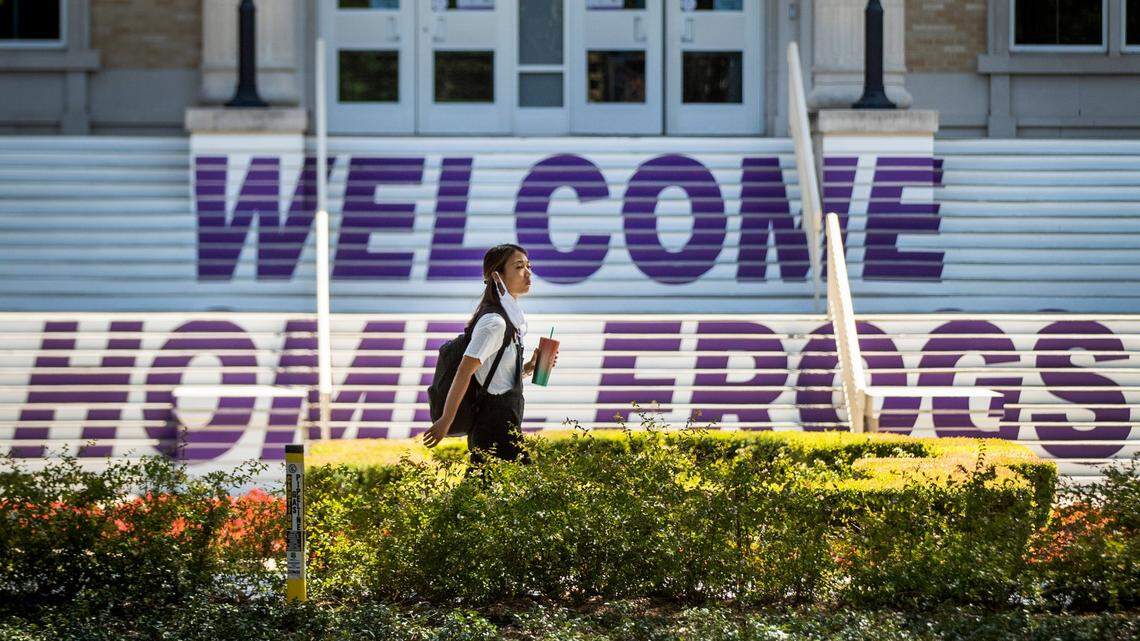 A student walks along University Drive to reach classes on Texas Christian University campus amid the coronavirus pandemicThursday, Aug. 20, 2020, in Fort Worth.