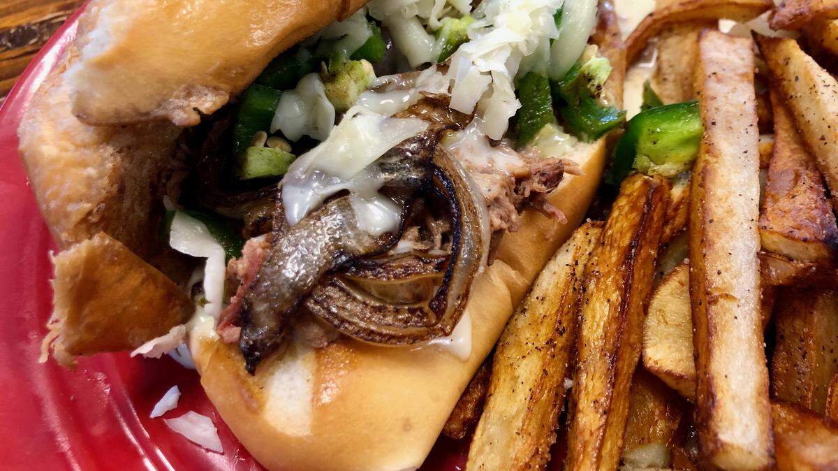 The “cowboy cheesesteak” at Enchiladas Ole is made with smoked brisket and white-cheddar queso.