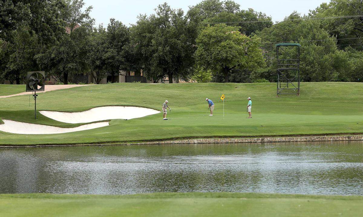 Golfers finish up on the green of the 13th hole at Colonial Country Club in this file photo from 2020. No. 13 is one of the best places for fans to watch the Charles Schwab Challenge.