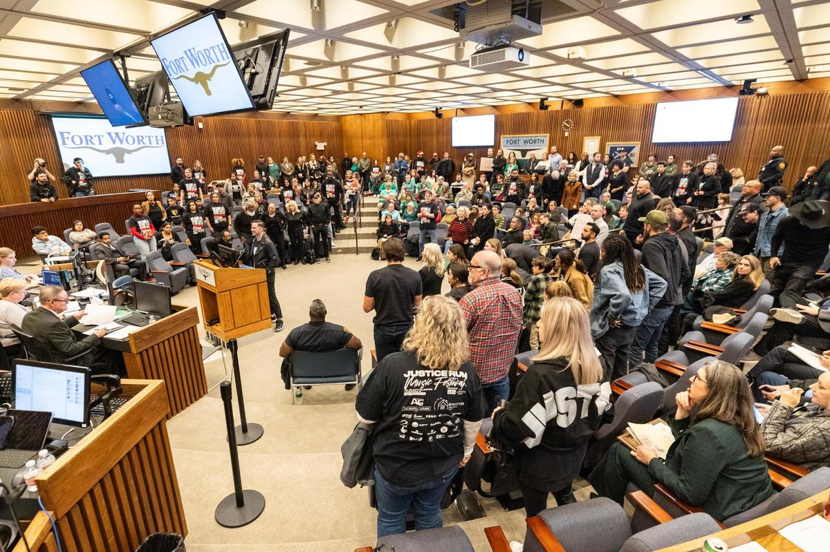 Landon Schott, the co-lead pastor of Mercy Culture Church, has the Mercy Culture Church supporters stand up with him while he speaks to the council members advocating for the approval of a proposed human trafficking victim shelter during a city council meeting in Fort Worth on Tuesday, Oct. 10, 2024.