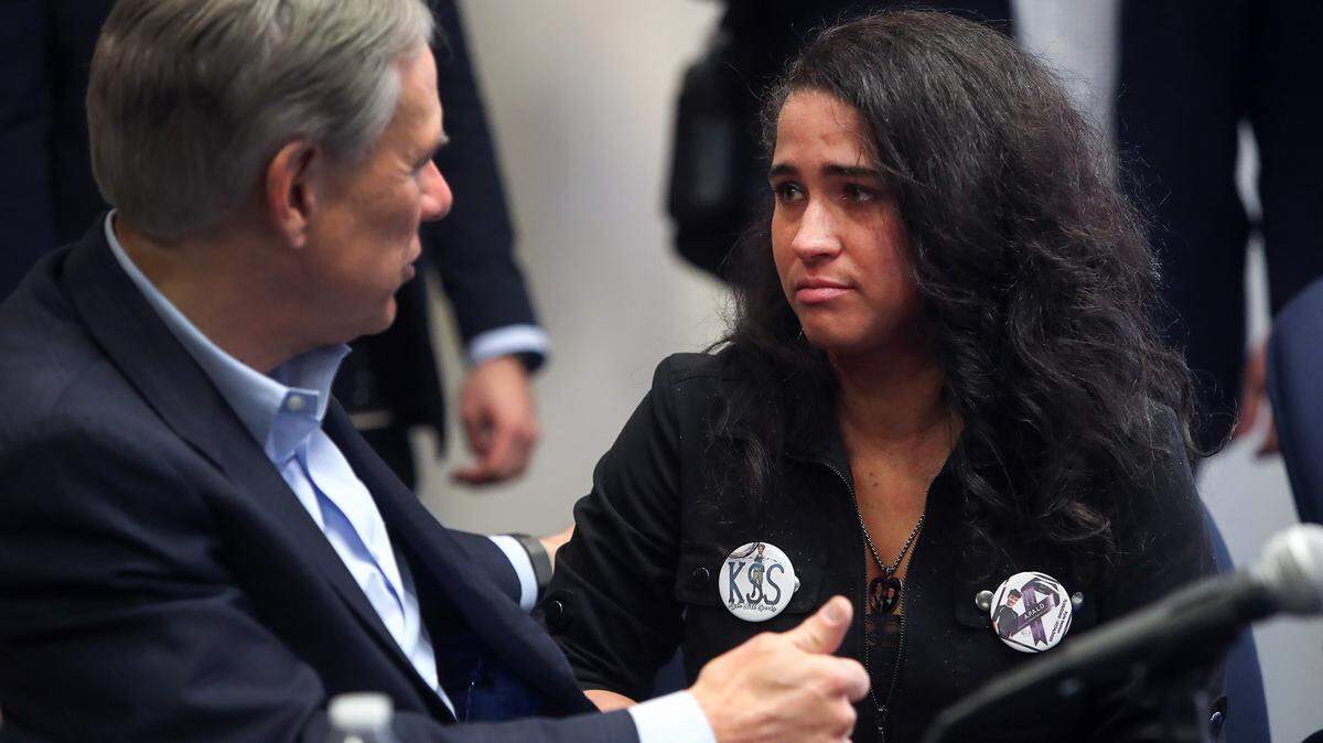 Stephanie Hellstern speaks to Gov. Greg Abbott following a press conference to discuss the fentanyl crisis on Tuesday, February 15, 2022. Hellstern’s son, Kyle Sexton, 16, died of an accidental fentanyl overdose in 2020.