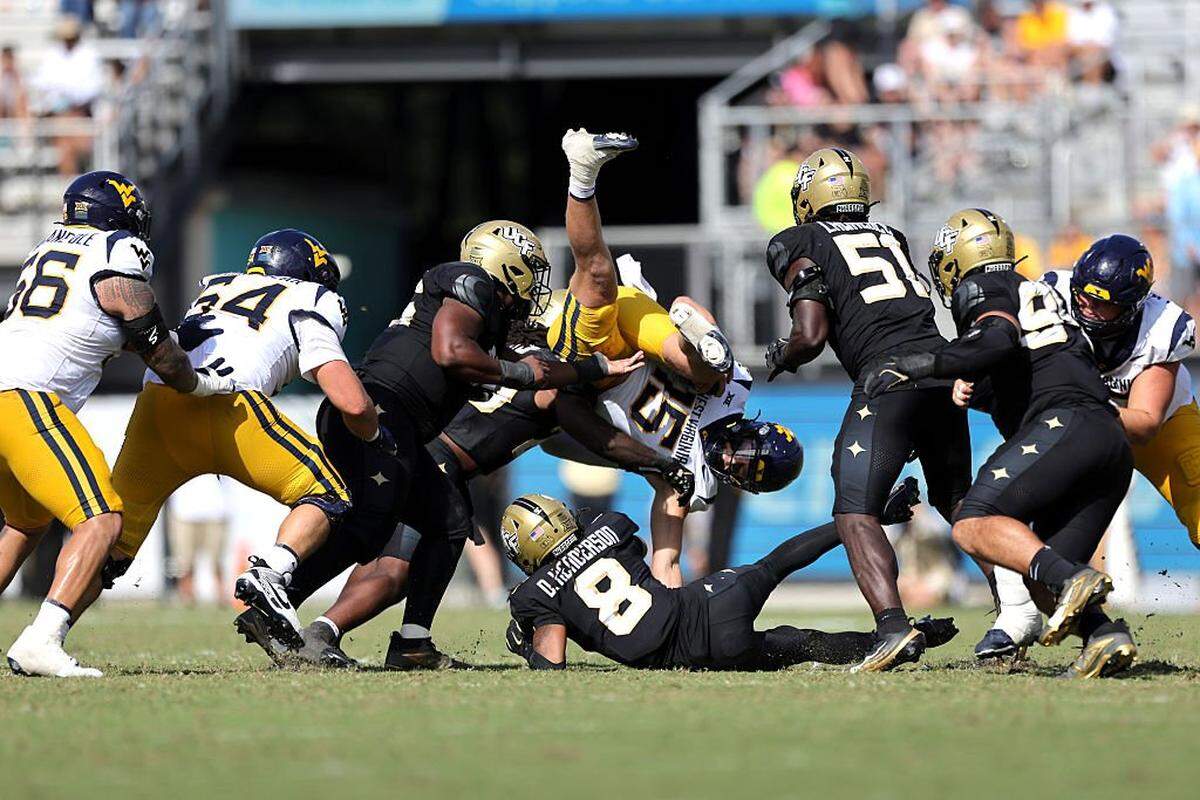 ORLANDO, FLORIDA - OCTOBER 18: Scotty Fox Jr. #15 of the West Virginia Mountaineers gets tacked in the 4th quarter of the game between the UCF Knights and West Virginia Mountaineers at FBC Mortgage Stadium on October 18, 2025 in Orlando, Florida. (Photo by Dustin Markland/Getty Images)
