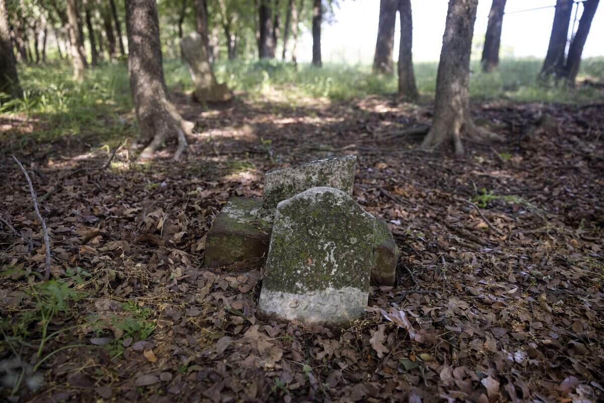 A damaged grave marks the place where someone is buried at St. John's Cemetery on Saturday, May 9, 2026, in Pilot Point, Texas. The cemetery is the last remaining evidence of the St. John's freedmen settlement community.