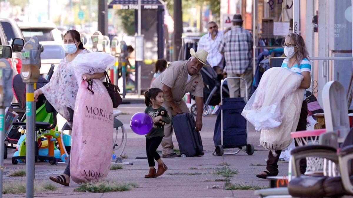 People are seen around the sidewalk on Jefferson Avenue in the Oak Cliff section of Dallas on Sept. 22, 2021. A closely watched estimate from the U.S. Census Bureau released Thursday indicates that Texas may have passed a long-awaited milestone: the point where Hispanic residents make up more of the state’s population than white residents.