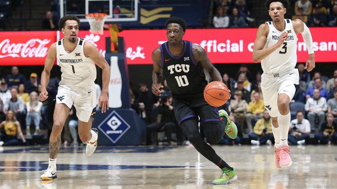 TCU guard Damion Baugh (10) is trailed by West Virginia forwards Emmitt Matthews Jr. (1) and Tre Mitchell (3) during the first half of an NCAA college basketball game Wednesday, Jan. 18, 2023, in Morgantown, W.Va.