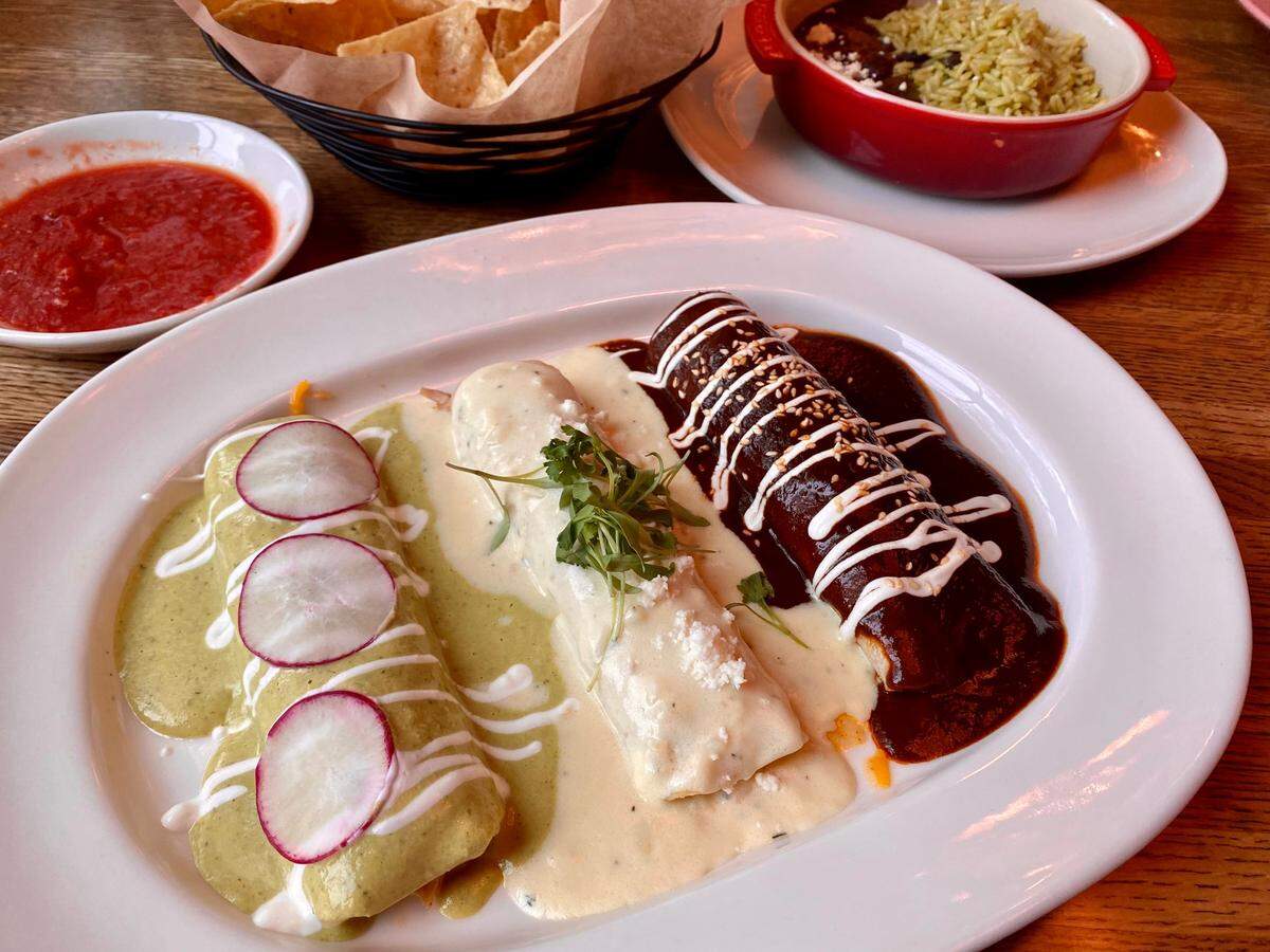 A Maria’s Mexican Kitchen plater of poblano, sour cream and mole enchiladas.