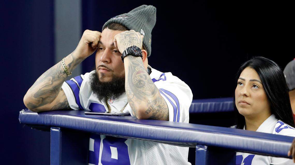 Dallas Cowboys fans react during the second half of an NFL wild-card playoff football game between the Cowboys and the San Francisco 49ers in Arlington, Texas, Sunday, Jan. 16, 2022. (AP Photo/Roger Steinman)