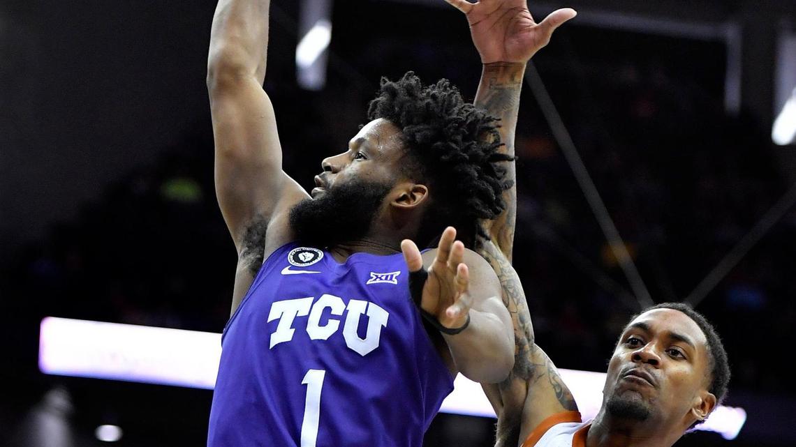 TCU’s Mike Miles, left, drives to the basket on Texas’ Jase Febres during the second half of Thursday’s Big 12 Tournament game in Kansas City. TCU beat Texas, 65-60.