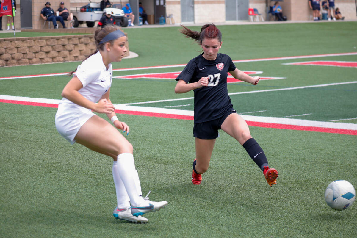 Colleyville Heritage freshman midfielder Brielle McDaniel attacks at Frisco Wakeland defense in a Class 5A state title game at Birkelbach Field on April 13, 2024.