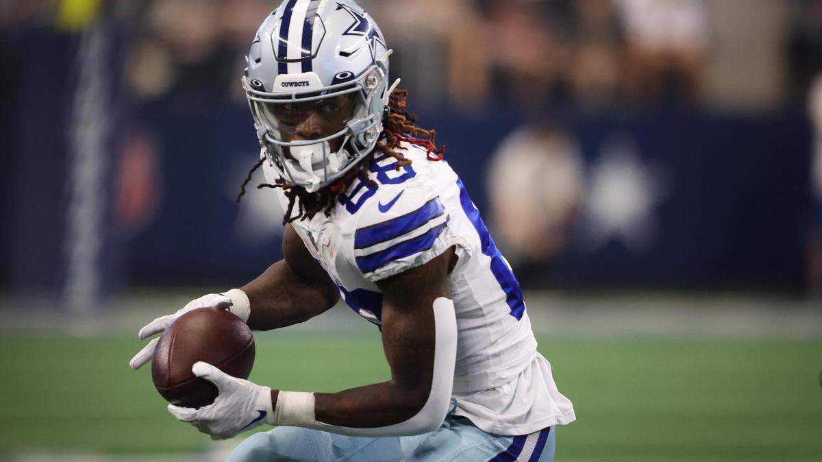 Dallas Cowboys CeeDee Lamb runs the ball during the game against Washington Commanders on Sunday, Oct. 2, 2022, at AT&T Stadium in Arlington.