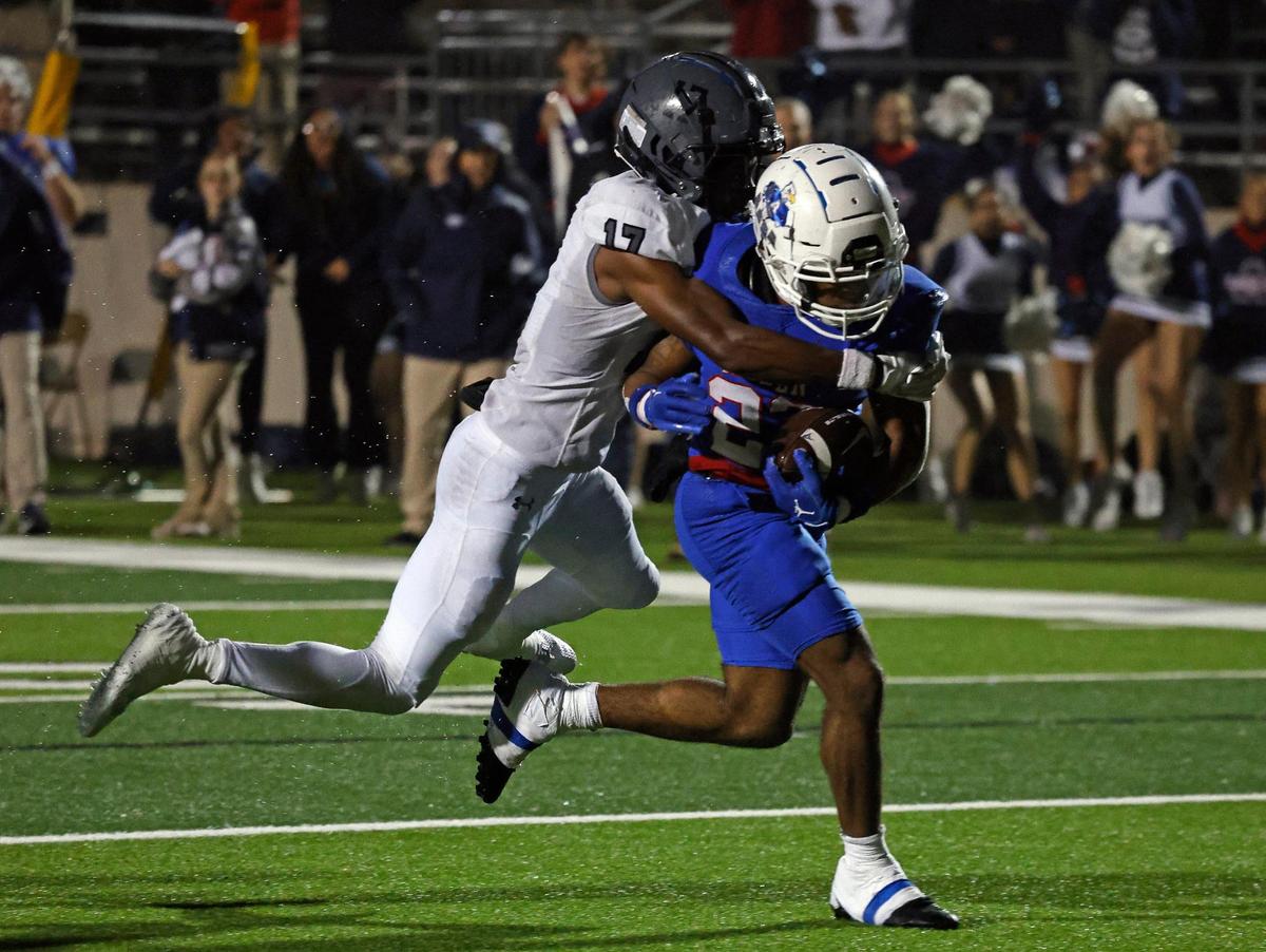 Allen running back Micah Ellis (23) carries Martin defensive back Zavien Abercrombie (17) to the end zone for the winning score in overtime of a UIL Conference 6A Division 1 area round football playoff game at Dragon Stadium in Southlake Texas, Friday, Nov. 17, 2023.