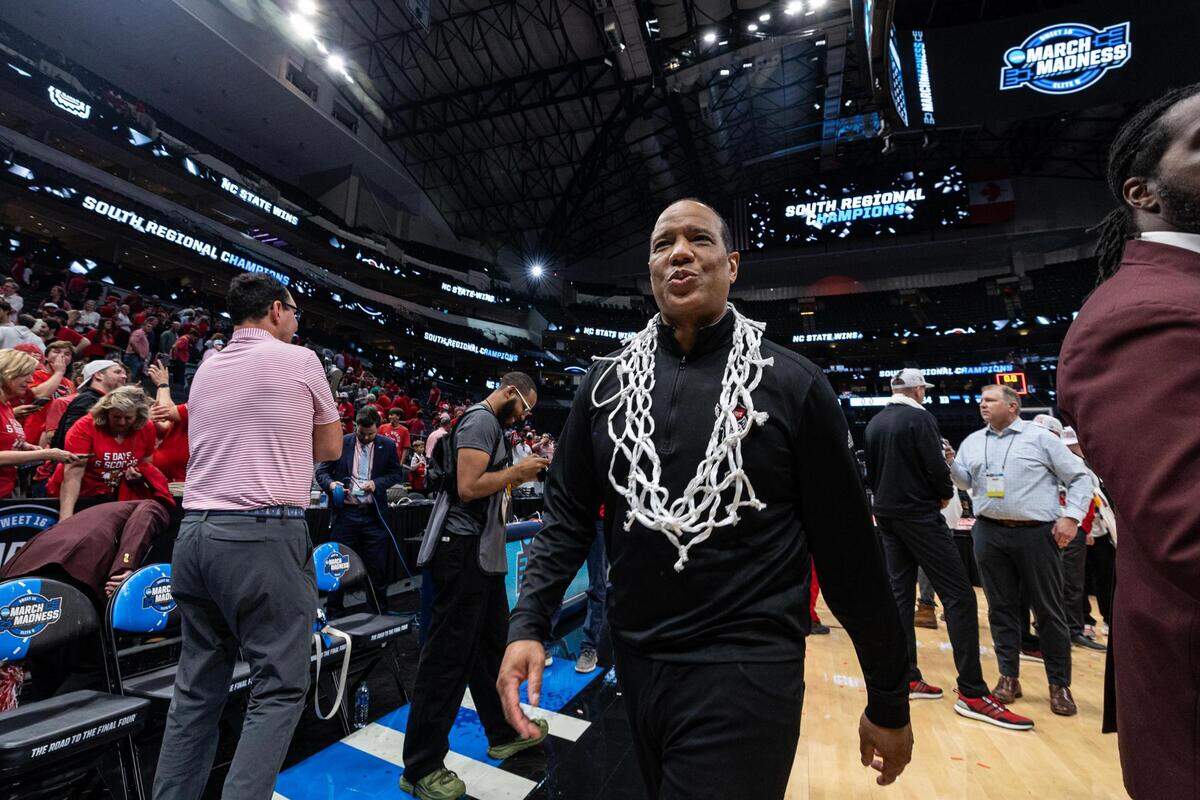 NC State Head Coach Kevin Keatts heads to the locker room wearing the net after winning their Elite 8 South Regional match up against the Duke Blue Devils and advance to the Final Four of the NCAA Division I Mens Basketball Tournament at American Airlines Center in Dallas on Sunday, March 31, 2024. NC State defeated Duke 76-64.