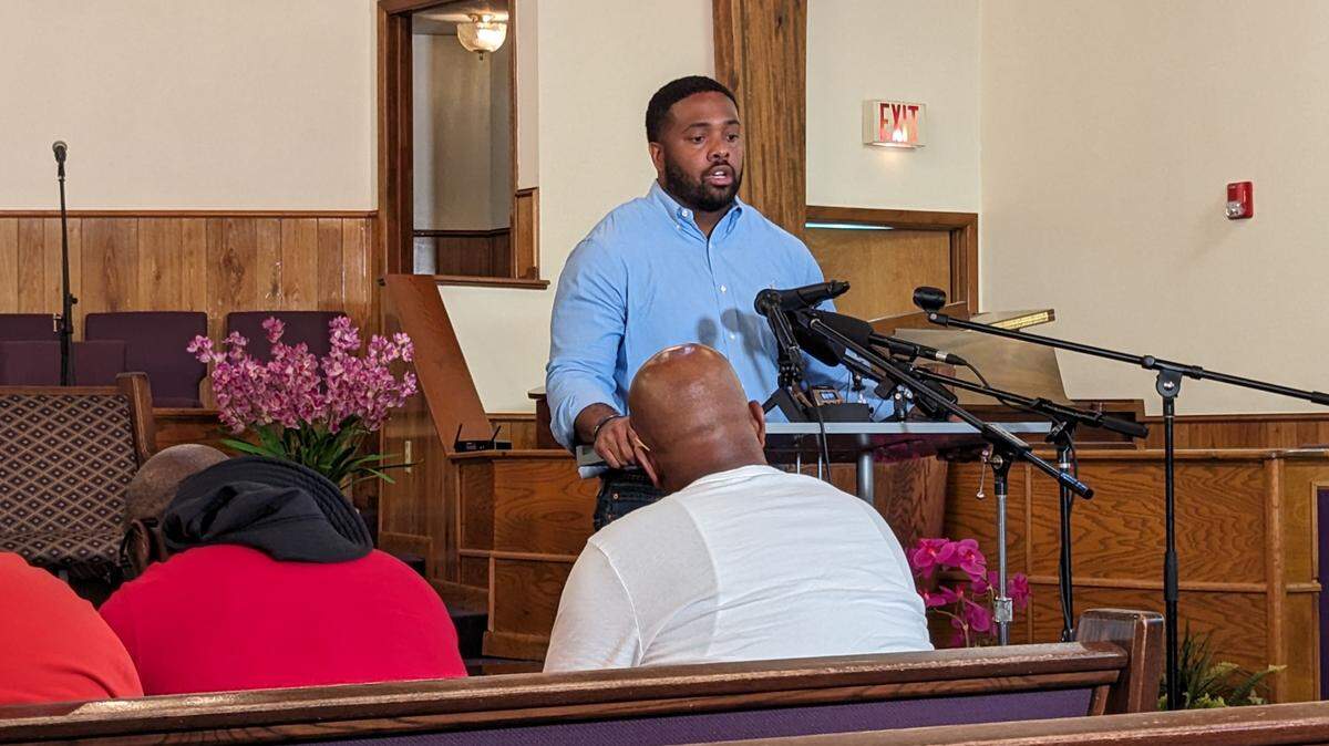 A man standing at a podium looking solemn