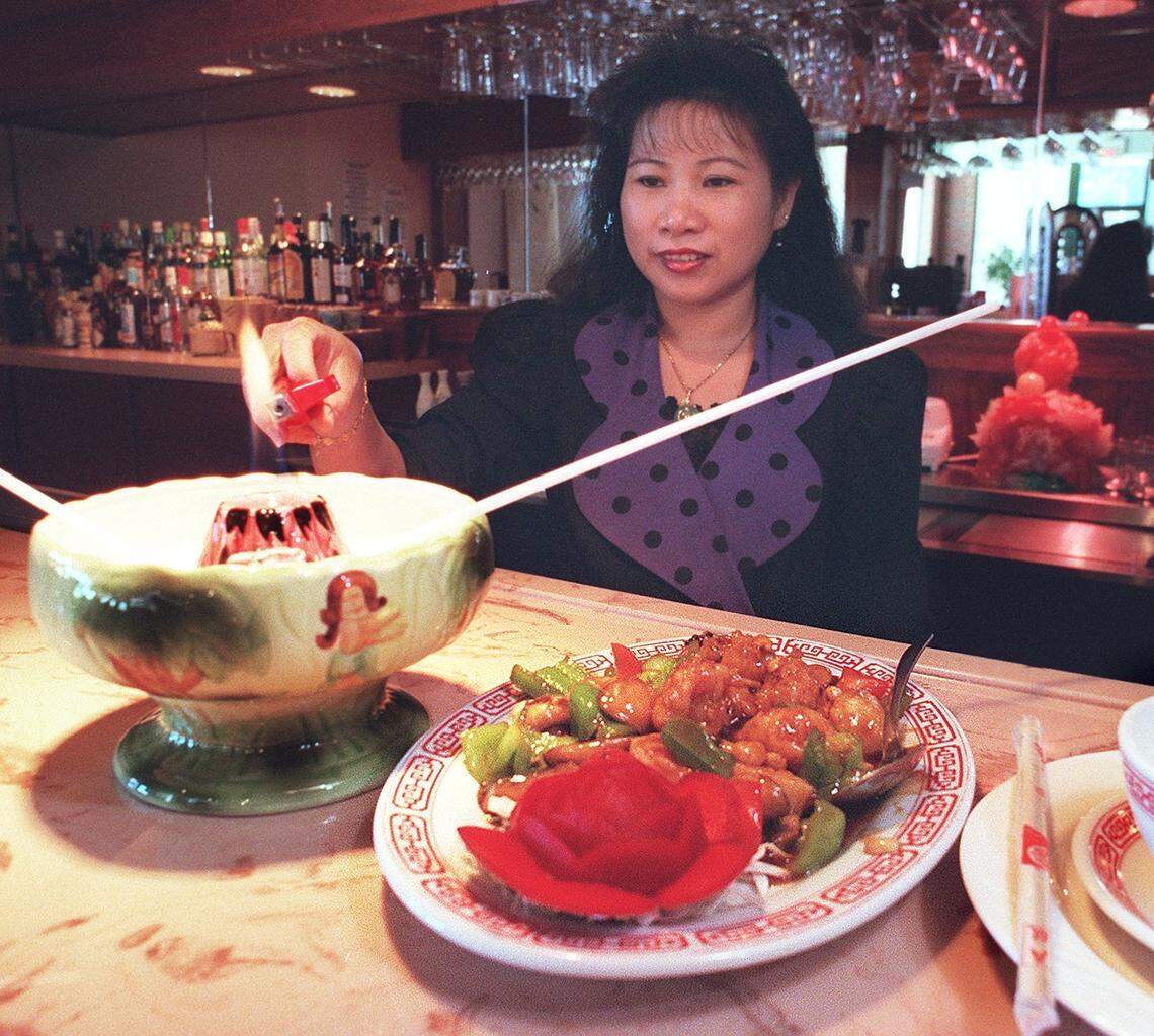 Sept. 30, 1999: Lisa Ayala lights a ‘Flaming Volcano’ to go with soup, and Kung Pao Deluxe, a scallop, shrimp and lobster dish, at Taiwan Restaurant at 4954 Overton Ridge Blvd., Fort Worth.