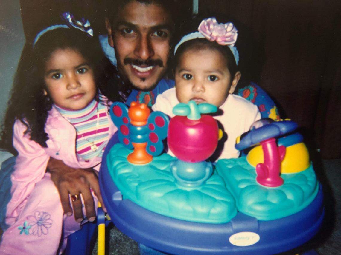 Arnulfo Omar Martinez (center) smiles in this photo with two of his daughters. The father of five loved to take his kids to the movies, or camping, or to see his horse, according to his wife and sister-in-law.