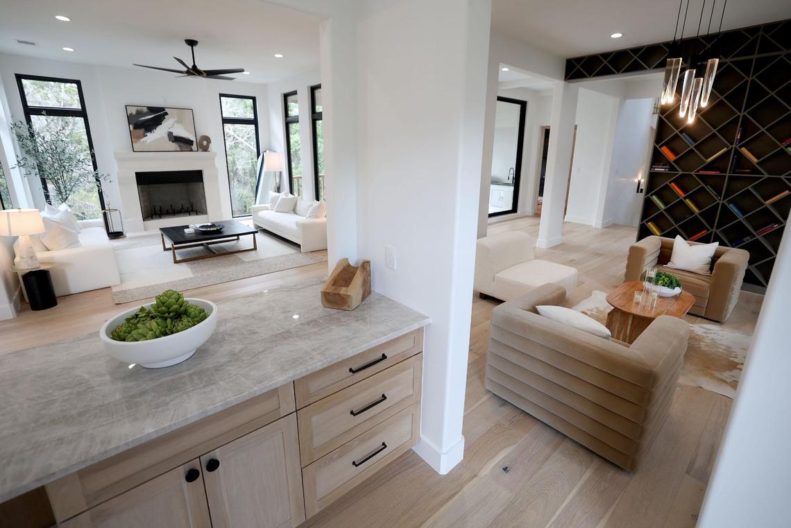 The living area of a newly built 7,019-square-foot home in the Silverado on the Brazos community features an open concept with a custom built in shelf.