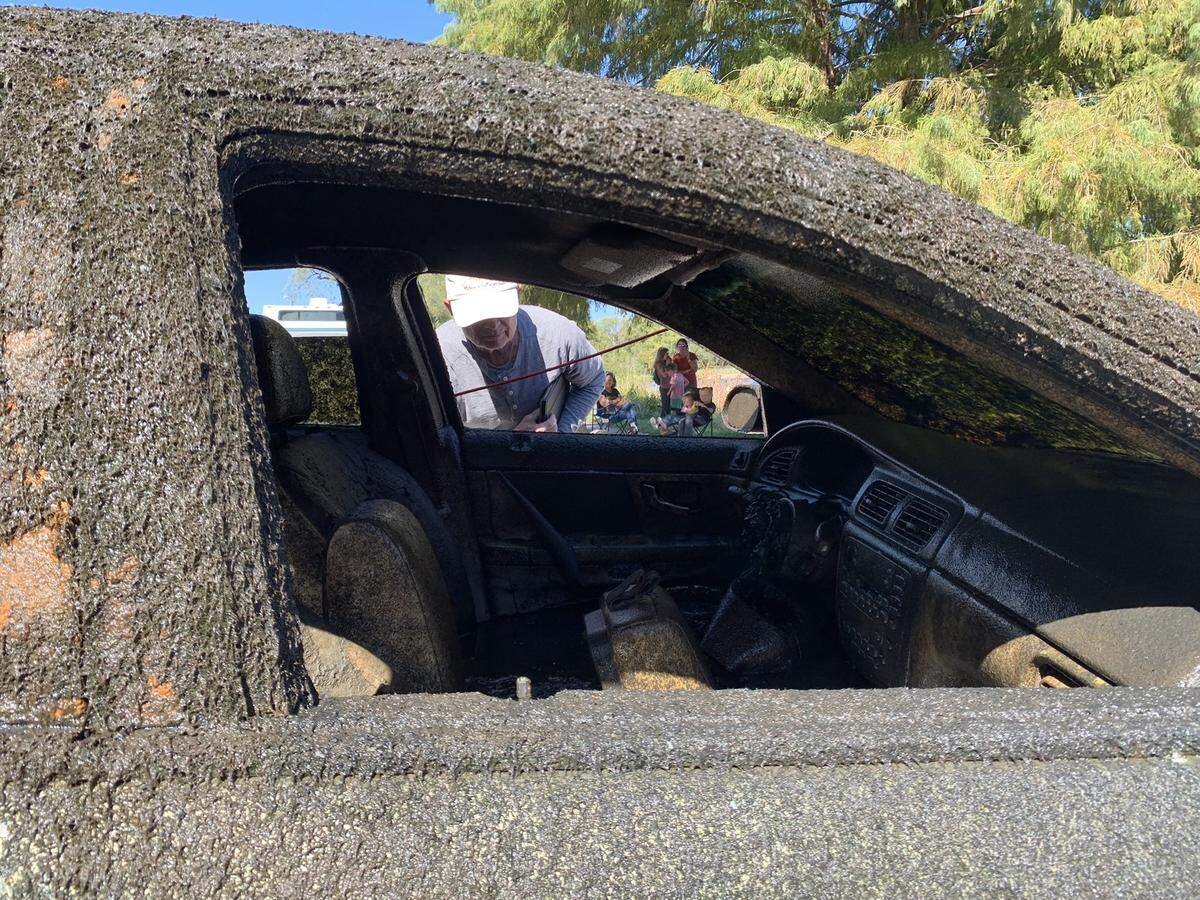 Divers pulled a car from Lake Como Tuesday morning during a four-day operation in Fort Worth as children and other onlookers watch. The Ford Taurus was located by various volunteer groups, including Adventures with Purpose and Depths of History.