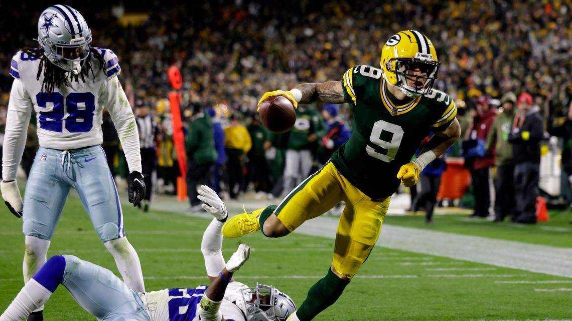 Green Bay Packers wide receiver Christian Watson (9) scores a touchdown after getting past Dallas Cowboys safety Malik Hooker (28) and cornerback DaRon Bland (26) during the second half of Sunday’s game in Green Bay.