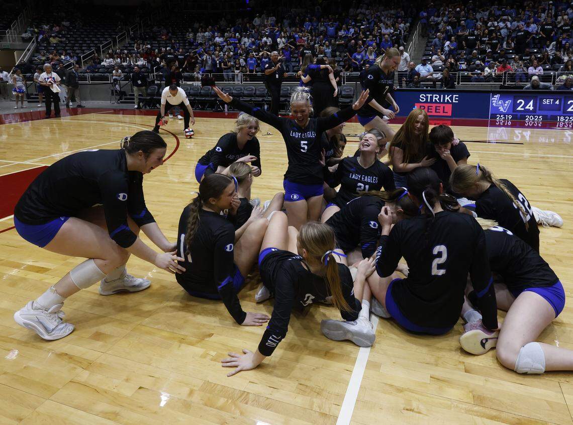 The Decatur Lady Eagles storm the court after winning the UIL Class 4A Division I state volleyball championship game against La Vernia on Friday at Curtis Culwell Center in Garland.
