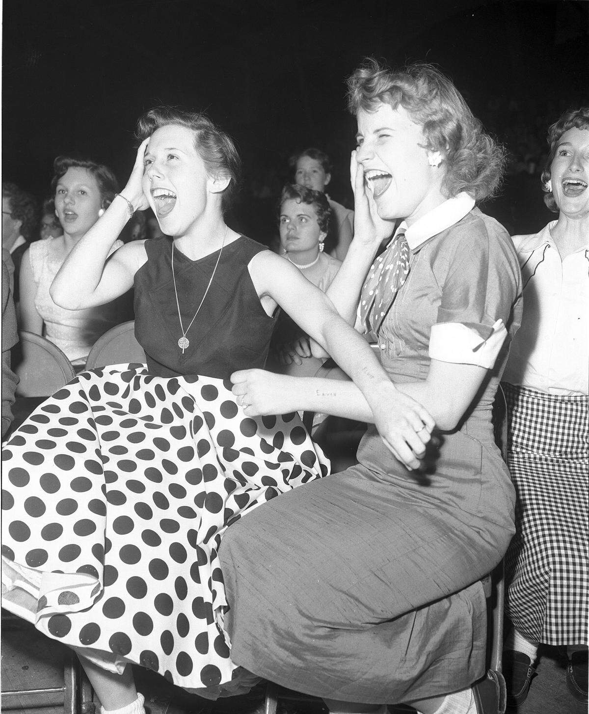April 20, 1956: Georgiana Blaylock, left, and Dolores Orms, both 16 from Dalla, with “Elvis” carved into their arms at his show in the Fort Worth Northside Coliseum