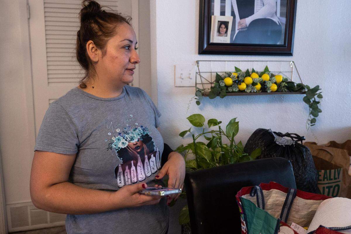 Cecilia Perez walks through her flooded home on Tuesday, Aug. 23, 2022, in Haltom City. The area received more than 9 inches of rain starting Sunday night.