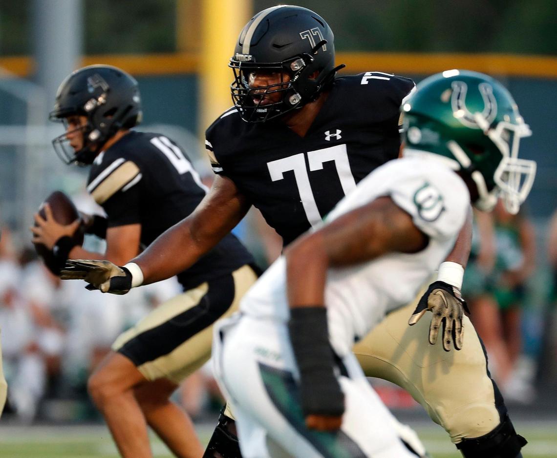 Fossil Ridge offensive lineman Lajuan Owens (77) protects the blind side of quarterback Logan Cundiff (4) in the first half of a high school football game at Keller ISD Stadium in Keller, Texas, Thursday, Sept. 08, 2022. Keller Fossil Ridge led 20-14 over Arlington High School at the half. (Special to the Star-Telegram Bob Booth)