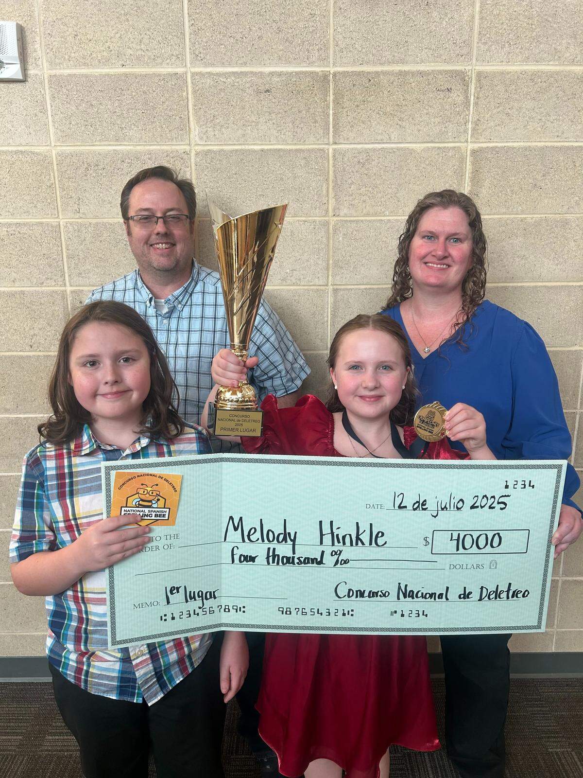 Melody Hinkle, center, won the National Spanish Spelling Bee in Albuquerque, New Mexico, on July 12. She’s shown here with her father Matthew Hinkle, mother Amy Hinkle and brother Mason Hinkle.