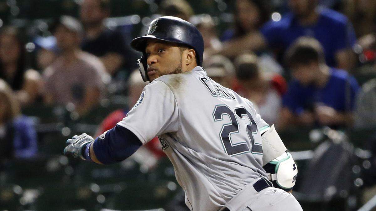 FILE - In this Sept. 22, 2018, file photo, Seattle Mariners’ Robinson Cano watches his double against the Texas Rangers during the seventh inning of a baseball game in Arlington, Texas. The New York Mets have acquired longtime star second baseman Cano and major league saves leader Edwin Diaz from the Seattle Mariners in a seven-player trade. (AP Photo/Michael Ainsworth, File)