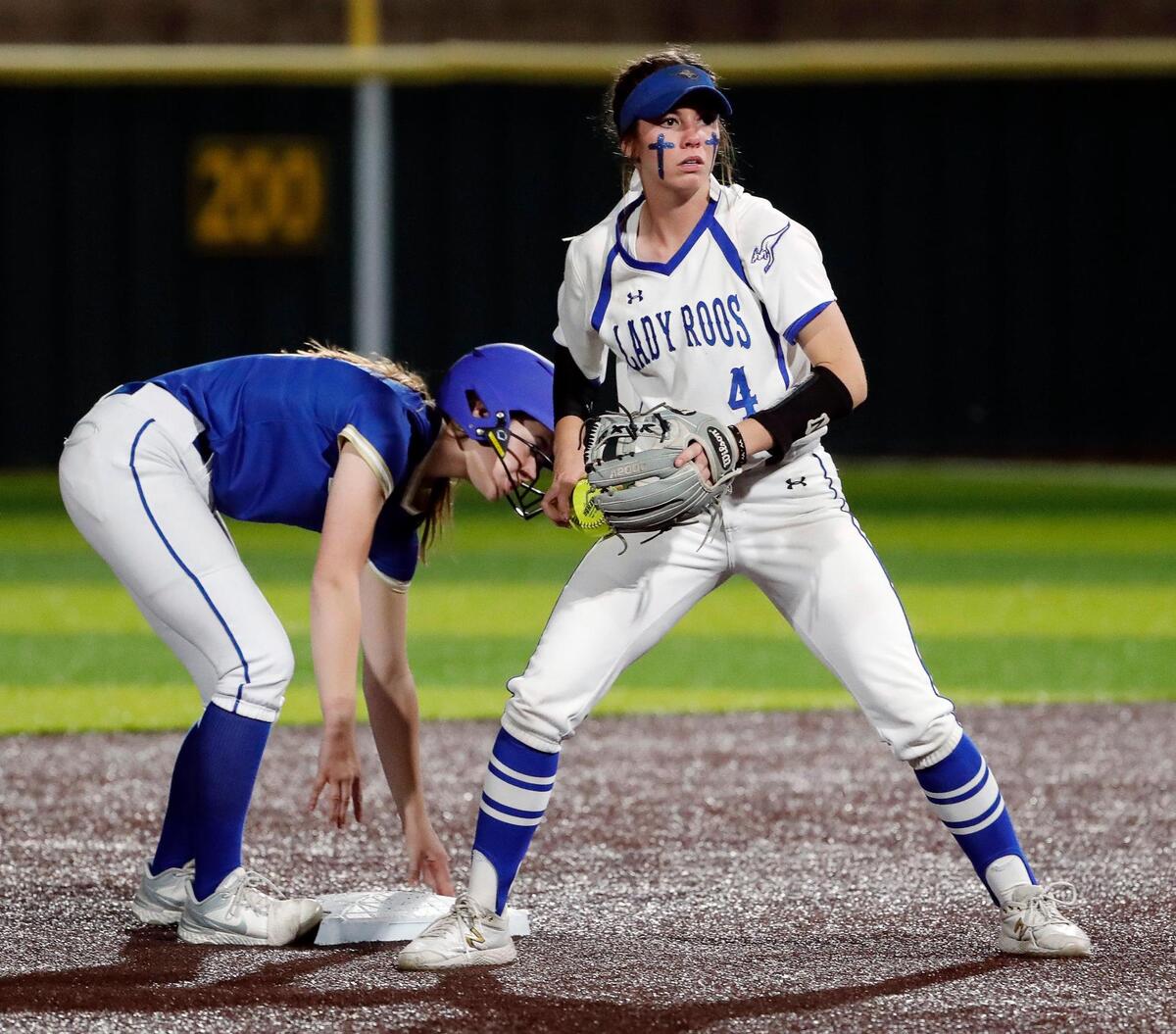 Weatherford short stop Hannah Reed (4) looks where to throw the ball as Boswell third baseman Byrdie Skipper (13) is safe at second during a 3-6A high school softball game at Weatherford High School in Weatherford, Texas, Tuesday, Apr. 05, 2022. Boswell defeated Weatherford 4-3. (Special to the Star-Telegram Bob Booth)