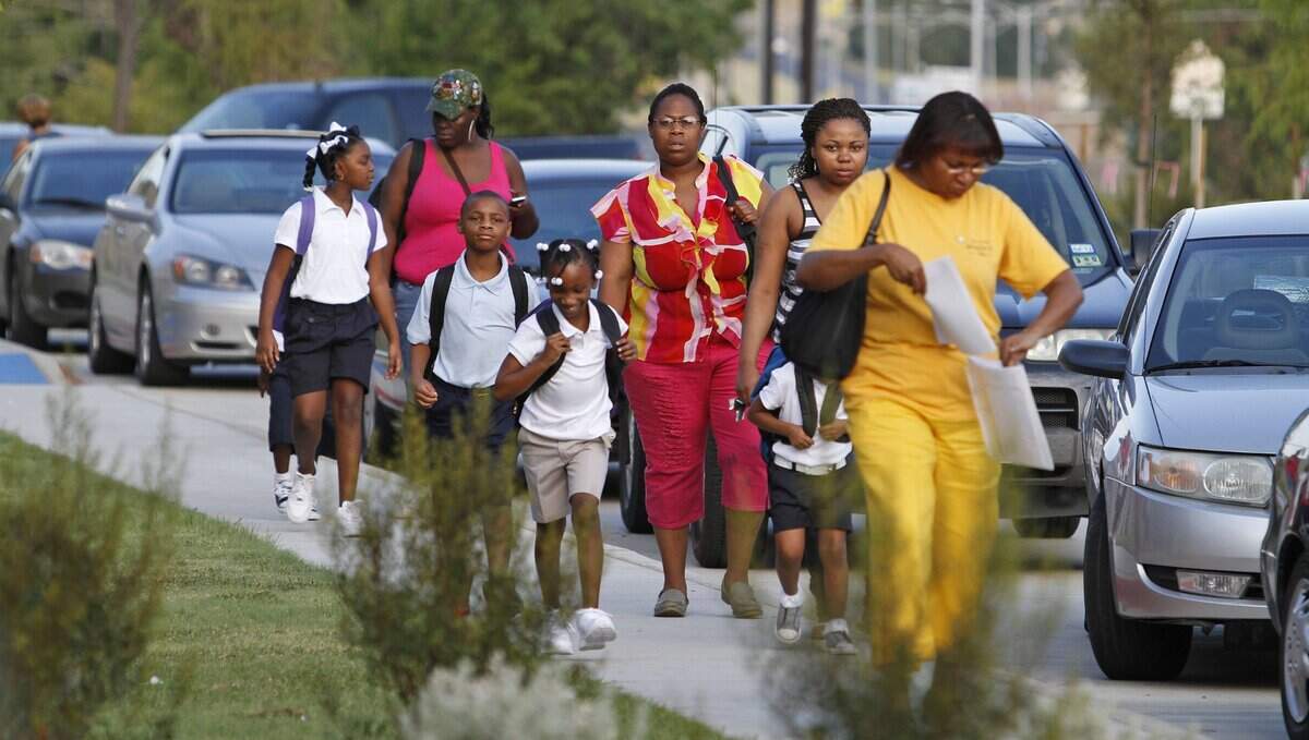 Aug. 22, 2011: Children and their parents head into White Elementary for the start of the school year. First day of school at the new John T. White Elementary in east Fort Worth. Fort Worth ISD is opening five new schools, four of which were built with the 2007 bond program money.