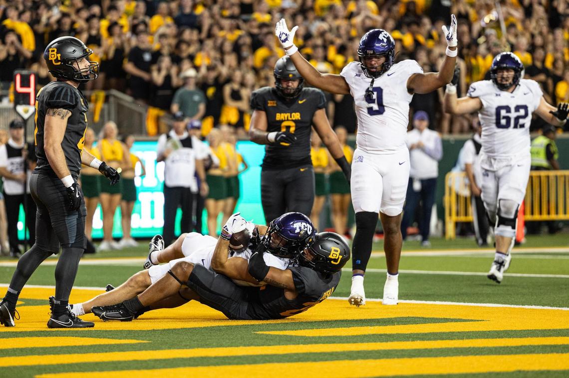 TCU wide receiver Jack Bech (18) catches a touchdown pass from wide receiver Savion Williams (3) in the second half of an NCAA football game between TCU and Baylor at McLane Stadium in Waco on Saturday, Nov. 2, 2024.