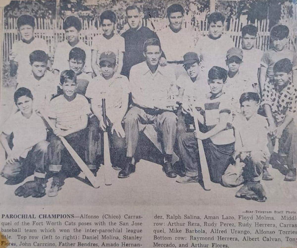 Baseball player Chico Carrasquel poses with the San Jose Catholic School team where bat boy Rudy Herrera attended. Rudy sits left of Carrasquel in this Star-Telegram photo.