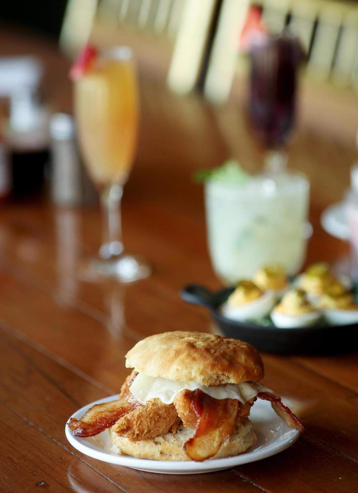 The Magnolia chicken biscuit at Brewed features crispy chicken, Texas smoked bacon, provolone cheese and spicy honey on a buttermilk biscuit.