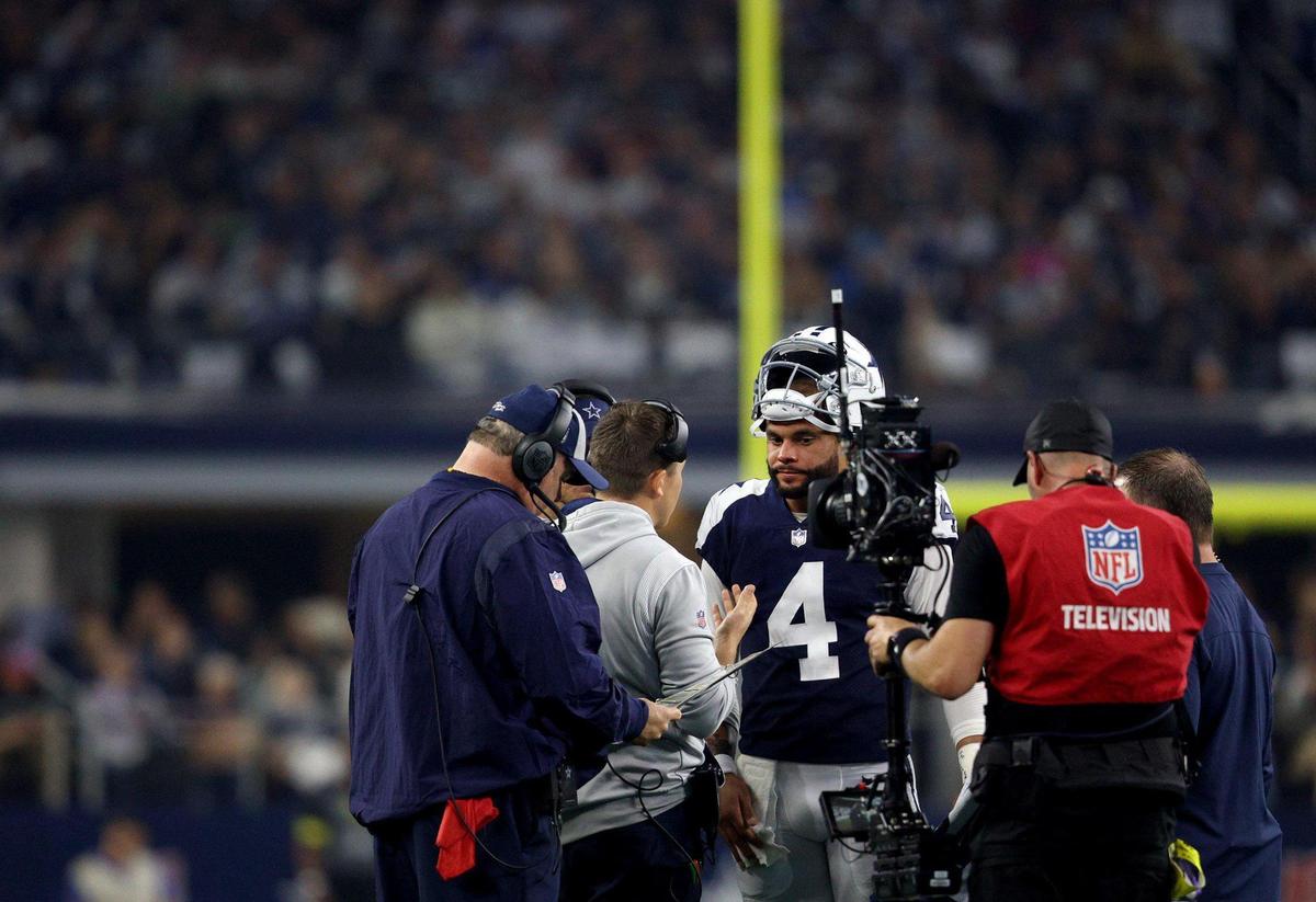 Dallas Cowboys quarterback Dak Prescott talks with offensive coordinator Kellen Moore on the sideline during the first half against the New York Giants on Thursday, November 24, 2022, at AT&T Stadium in Arlington.