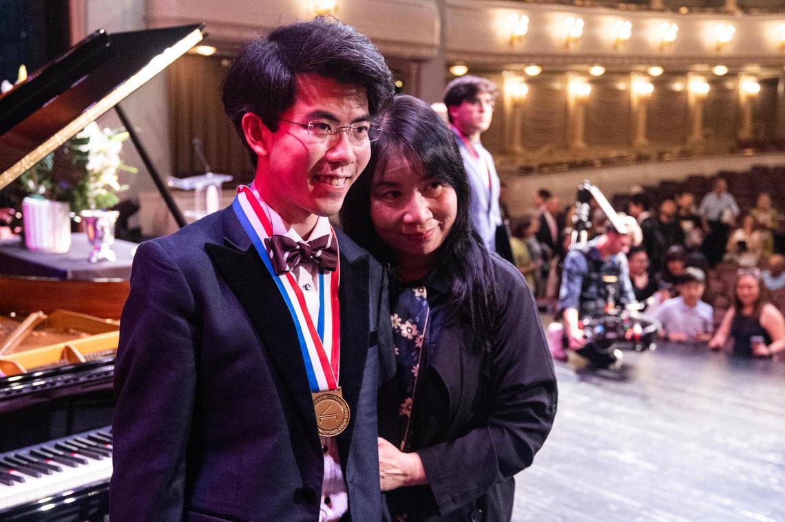 Aristo Sham of Hong Kong, China takes a photo with his mother Jessica after winning the Nancy Lee and Perry Bass Gold Medal award and Van Cliburn Winners Cup during the Van Cliburn International Piano Competition Awards Ceremony at Bass Performance Hall in Fort Worth on Saturday, June 7, 2025.