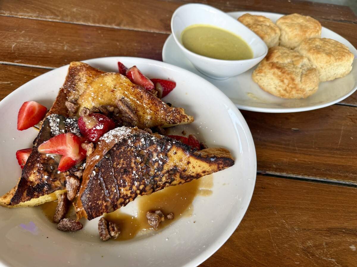 Churro French toast with caramel and strawberries, foreground, and biscuits with jalapeño cream gravy at Rex’s Bar & Grill, seen July 11, 2026.