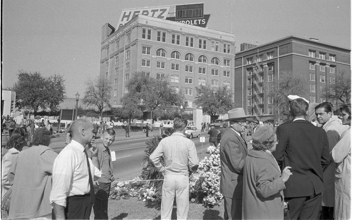Nov. 23, 1963: Dealey Plaza and the Texas State Book Depository building with crowds on street mourning the assassination of President John F. Kennedy the day after the shooting.