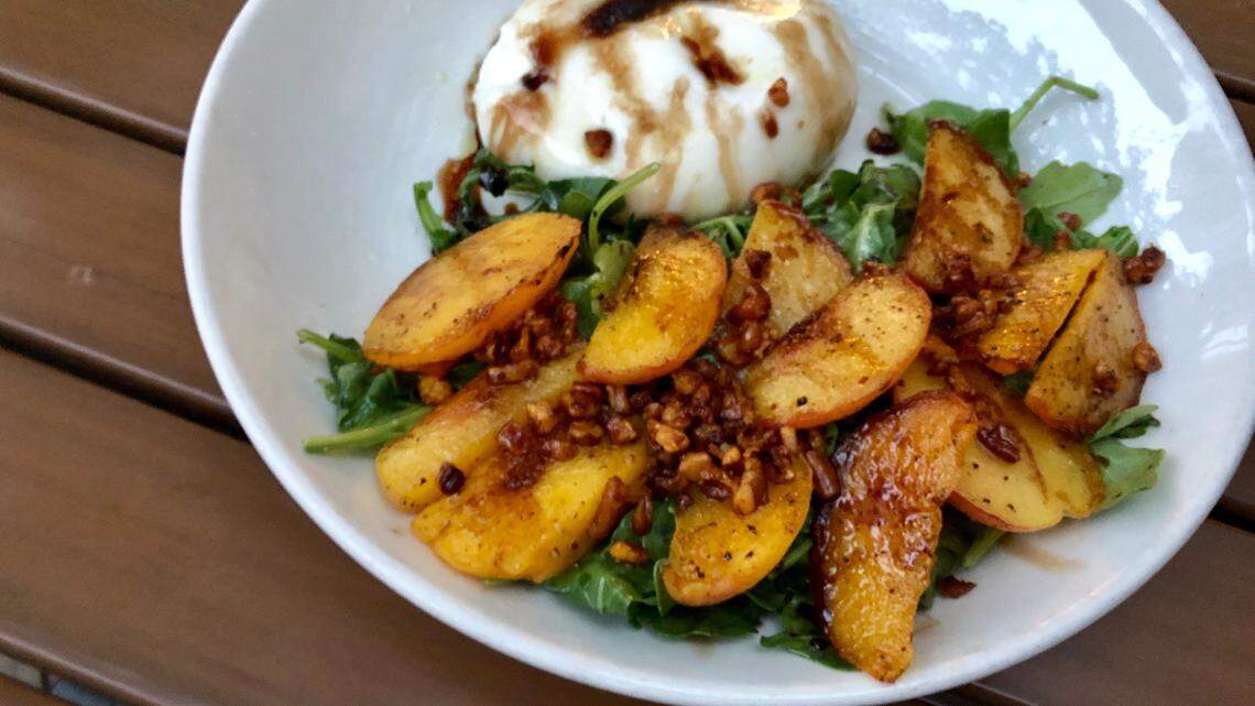 A peach-pecan-arugula salad at Fireside Pies in Crockett Row.