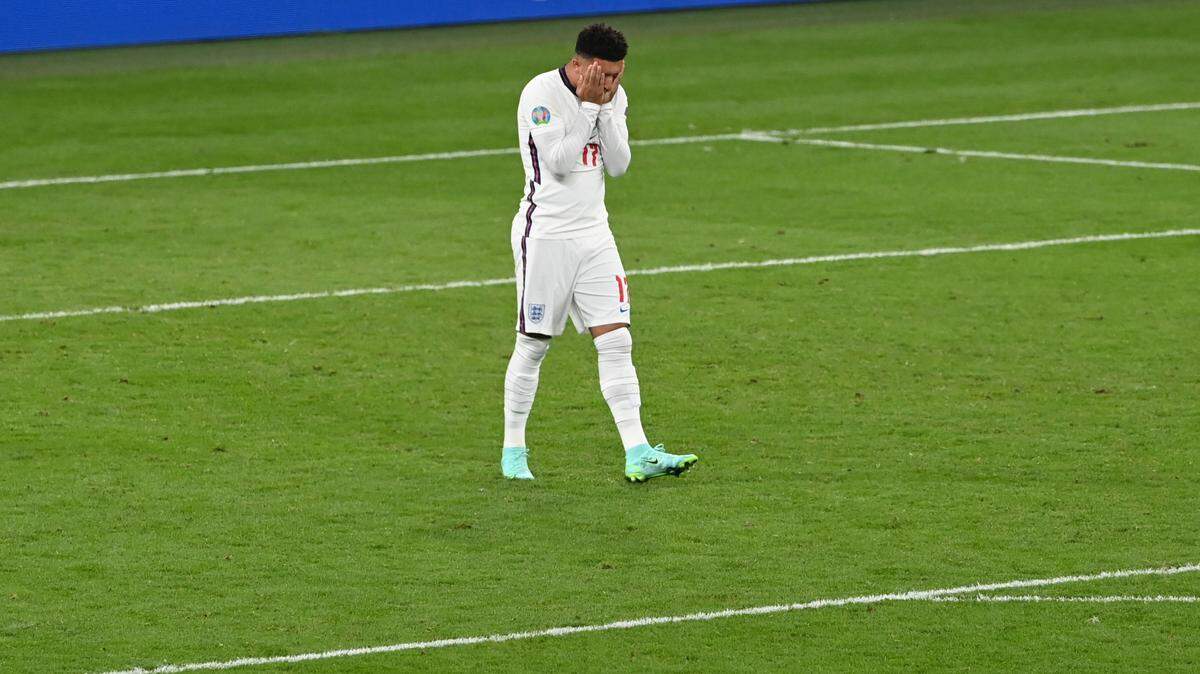England’s Jadon Sancho reacts after missing a chance to score during the penalty shoot out of the Euro 2020 final soccer match between Italy and England at Wembley stadium in London, Sunday, July 11, 2021. (Facundo Arrizabalaga/Pool via AP)