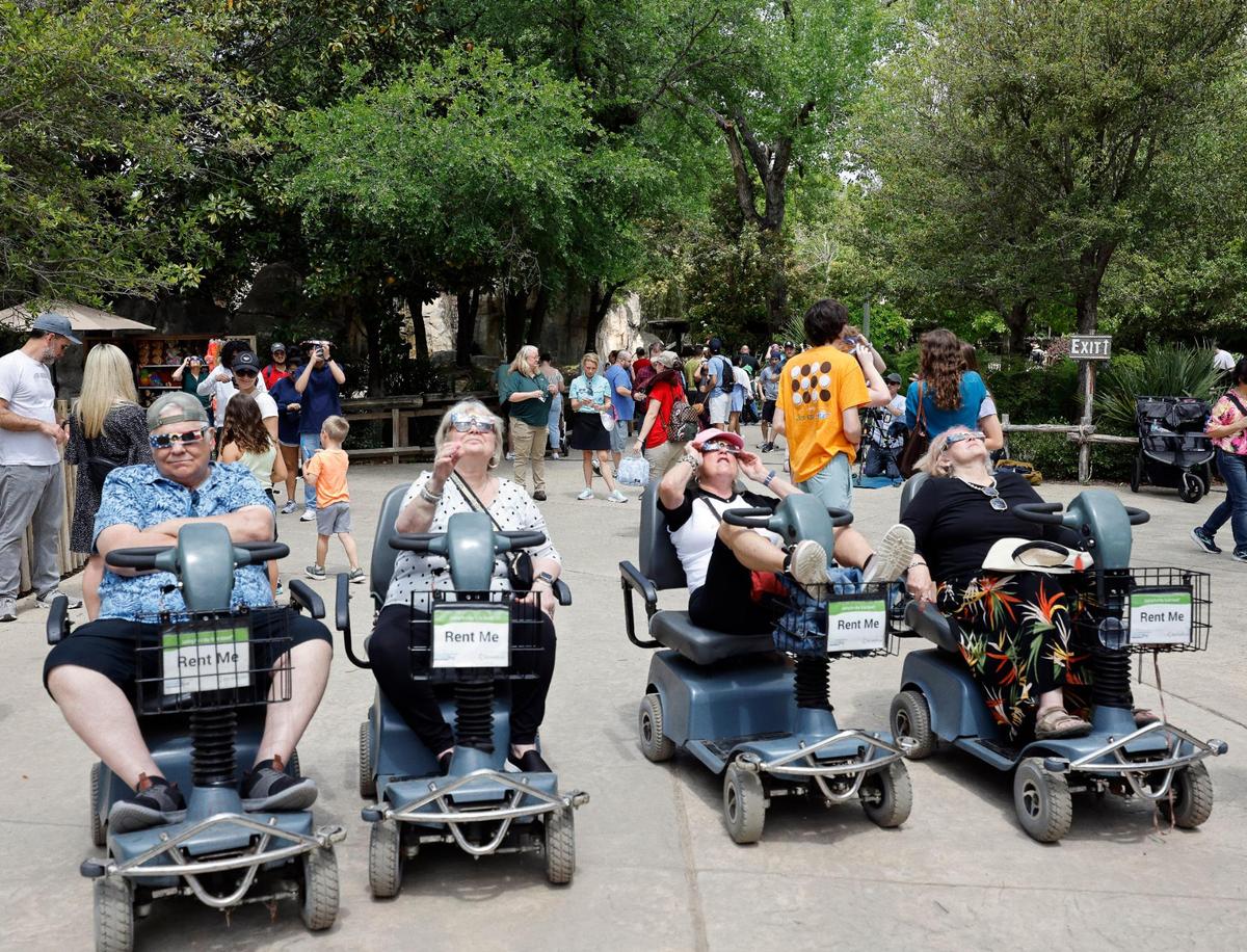 People lined up near the entrance to view the total solar eclipse at the Fort Worth Zoo in Fort Worth, Texas, Monday Apr 08, 2024.