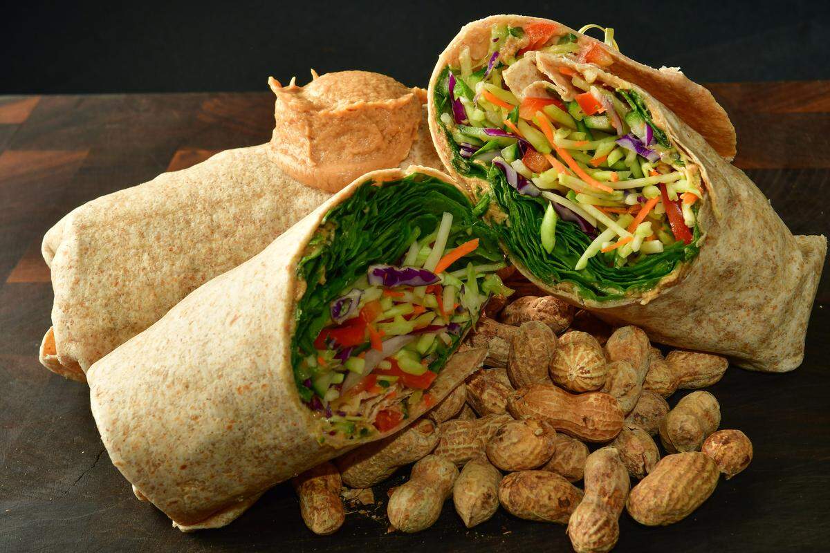 Thai veggie wrap with spicy peanut sauce at AT&T Stadium: broccoli slaw, sweet peppers, and spicy Thai peanut sauce piled high on a bed of baby spinach and rolled in a whole wheat tortilla