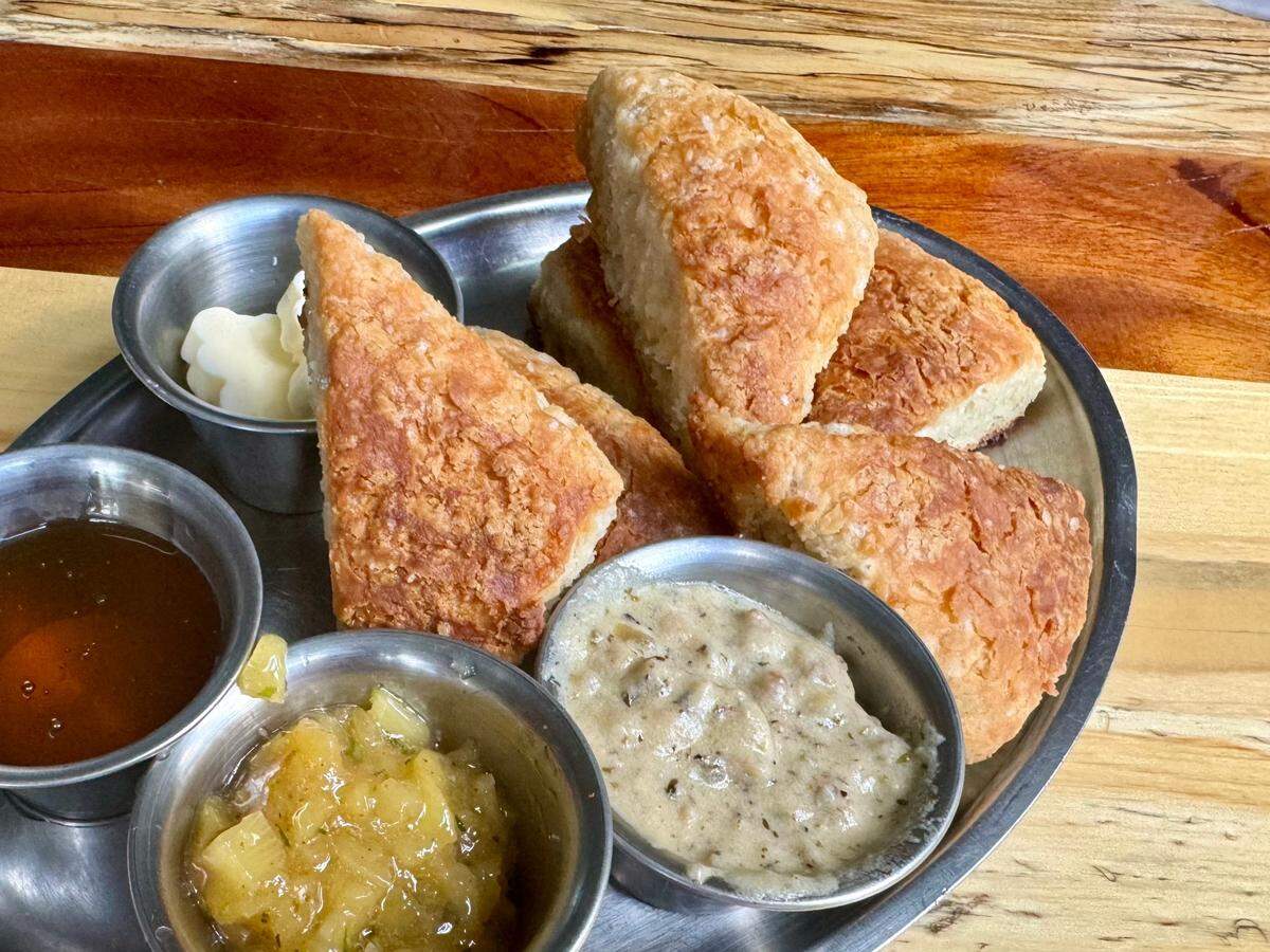 The Woodshed Smokehouse serves pan-baked “campfire” biscuits on weekends with butter, honey, sausage gravy and jam, as seen June 22, 2024.