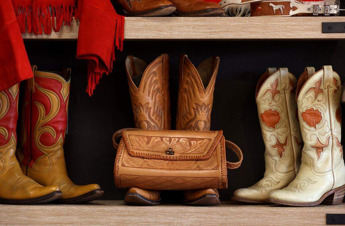 Vintage boots and western wear are displayed at Studio 74 Vintage in Fort Worth on Thursday, December 23, 2021. Laura Simmons is the owner of the boutique shop that sells curated vintage clothing.